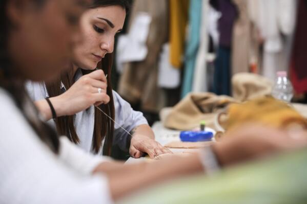 A tailor works on stage costumes in the "Teatro dell' Opera" opera house costumes laboratory, in Rome, Thursday, April 10, 2025. (AP Photo/Andrew Medichini)