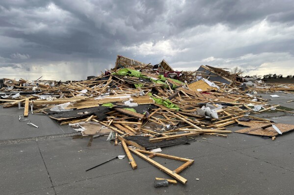 Debris is seen from a destroyed home northwest of Omaha, Neb., after a storm tore through the area on Friday, April 26, 2024. (AP Photo/Margery A. Beck)
