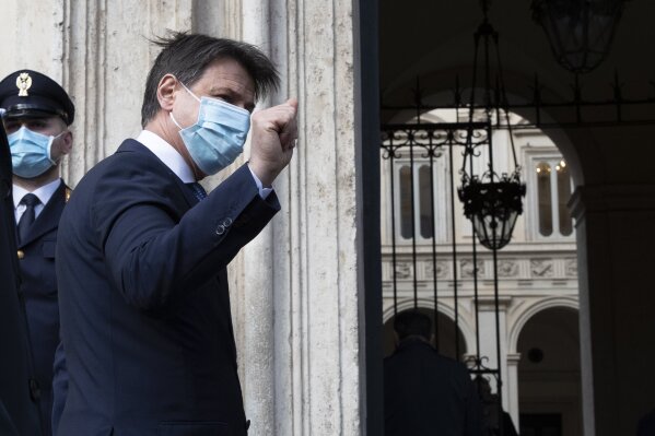 Outgoing Italian Premier Giuseppe Conte waves after meeting journalists outside Chigi palace Premier's office in Rome, Thursday, Feb. 4, 2021. The former European Central Bank chief, Mario Draghi, credited with helping to save the euro has now been tapped to lead Italy out of the pandemic and the worst recession since World War II. (AP Photo/Alessandra Tarantino)