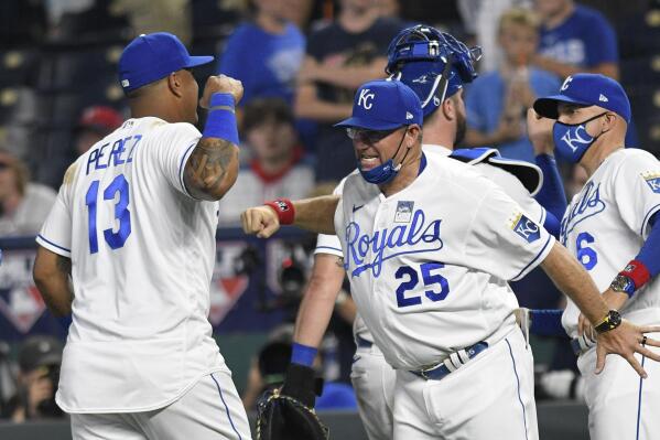 Kansas City Royals' Salvador Perez (13) is congratulated by third base coach Vance Wilson (25) after the team's 6-5 win over the Minnesota Twins in a baseball game Thursday, June 3, 2021, in Kansas City, Mo. Perez had two home runs in the game. (AP Photo/Reed Hoffmann)