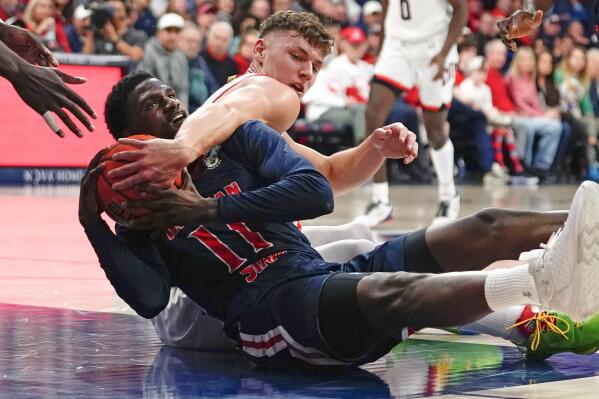 Arizona's Pelle Larsson, right, wraps up Morgan State's Malik Miller, left, as they battle for loose ball during the first half of an NCAA college basketball game, Thursday, Dec. 22, 2022, in Tucson, Ariz. (AP Photo/Darryl Webb)