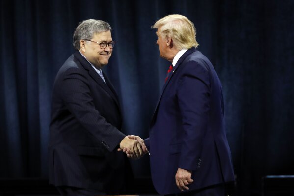 FILE - In this Oct. 28, 2019, file photo, President Donald Trump shakes hands with Attorney General William Barr before Trump signed an executive order creating a commission to study law enforcement and justice at the International Association of Chiefs of Police Convention in Chicago. Attorney General William Barr took a public swipe Thursday at President Donald Trump, saying that the president’s tweets about Justice Department prosecutors and cases “make it impossible for me to do my job.”  Barr made the comment during an interview with ABC News just days after the Justice Department overruled its own prosecutors. they had initially recommended in a court filing that President Donald Trump’s longtime ally and confidant Roger Stone be sentenced to 7 to 9 years in prison. But the next day, the Justice Department took the extraordinary step of lowering the amount of prison time it would seek for Stone.  (AP Photo/Charles Rex Arbogast, File)