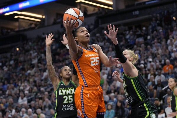 Connecticut Sun forward Alyssa Thomas (25) shoots as Minnesota Lynx forward Dorka Juhasz, right, defends during the first half of Game 3 of a WNBA first-round basketball playoff series Wednesday, Sept. 20, 2023, in Minneapolis. (AP Photo/Abbie Parr)