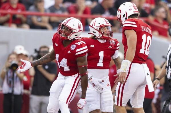 Nebraska's Billy Kemp IV (1) celebrates a touchdown with teammates Rahmir Johnson (14) and quarterback Heinrich Haarberg (10) against Northern Illinois during the first half of an NCAA college football game, Saturday, Sept. 16, 2023, in Lincoln, Neb. (AP Photo/Rebecca S. Gratz)