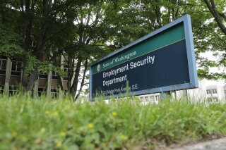 FILE - In this May 26, 2020, file photo, is a sign at the headquarters for Washington state's Employment Security Department at the Capitol in Olympia, Wash. Washington officials say they believe they have recovered about half of the up to $650 million in unemployment benefits paid to criminals who used stolen identities to file claims during the coronavirus pandemic. (AP Photo/Ted S. Warren, File)