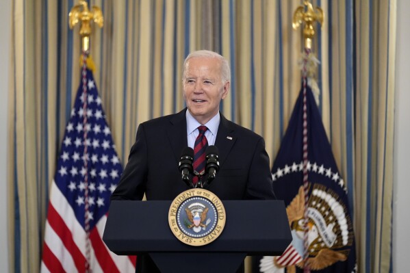 FILE - President Joe Biden speaks during a meeting of his Competition Council to announce new actions to lower costs for families in the State Dining Room of the White House in Washington, Tuesday, March 5, 2024. Democrats in Hawaii are voting on their party’s nominee for president. There has been little visible campaigning in the islands but Biden has a large advantage. Others on the ballot include U.S. Rep. Dean Phillips and self-help author and spiritual guru Marianne Williamson. (AP Photo/Andrew Harnik, File)
