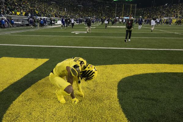 Oregon wide receiver Kris Hutson (1) kneels in the end zone after the final play fell short against Washington during the second half of an NCAA college football game Saturday, Nov. 12, 2022, in Eugene, Ore. (AP Photo/Andy Nelson)