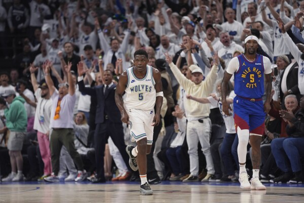 Minnesota Timberwolves guard Anthony Edward, left, runs down the court after making a 3-point shot against the Denver Nuggets during the first half of Game 6 of an NBA basketball second-round playoff series Thursday, May 16, 2024, in Minneapolis. (Ǻ Photo/Abbie Parr)