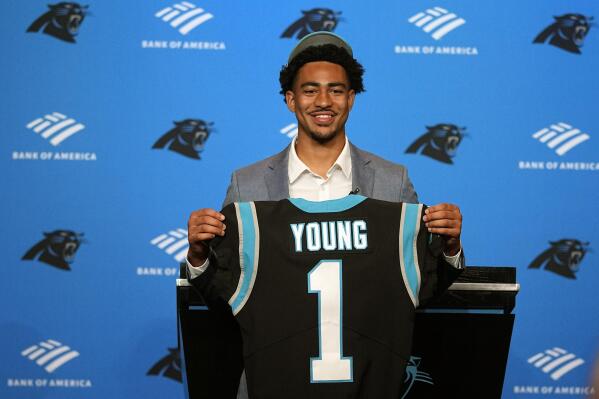 Carolina Panthers number one draft pick quarterback Bryce Young poses with his jersey during a news conference at their NFL football stadium on Friday, April 28, 2023, in Charlotte, N.C. (AP Photo/Chris Carlson)