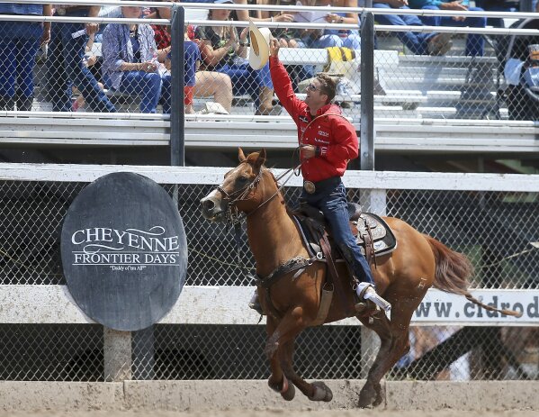 FILE - In this July 29, 2018, file photo, Shane Hanchey, of Sulphur, La., takes a lap and acknowledges the crowd after winning the tie-down roping event during Championship Sunday of the 122nd annual Cheyenne Frontier Days Rodeo at Frontier Park Arena in Cheyenne, Wyo. Cheyenne Frontier Days has been canceled for the first time in its 124-year history due to the coronavirus. Cheyenne Mayor Marian Orr said Wednesday, May 27, 2020 that organizers decided the risk of spreading the coronavirus was too great for the more than 140,000 people who visit Cheyenne for Frontier Days in late July. (Blaine McCartney/The Wyoming Tribune Eagle via AP, File)