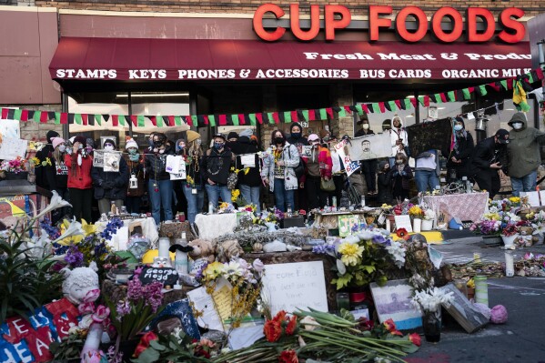 FILE - Demonstrators gather outside Cup Foods to celebrate the murder conviction of former Minneapolis police officer Derek Chauvin in the killing of George Floyd, April 20, 2021, in Minneapolis. Several stores at the location where Floyd was killed by Minneapolis police in 2020 have sued the city, accusing it of neglecting the area and hurting business. The lawsuit, filed in mid-November in state court, names the city, Mayor Jacob Frey and other officials and accuses the city of not properly policing the area since Floyd’s death. It also accuses the city of blocking the intersection that is now known as George Floyd Square with concrete barriers for more than a year after Floyd's death, keeping customers from entering. (AP Photo/John Minchillo, File)