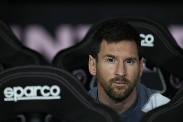 Inter Miami forward Lionel Messi sits on the bench as a potential substitute ahead of an MLS soccer match against FC Cincinnati, Saturday, Oct. 7, 2023, in Fort Lauderdale, Fla. (AP Photo/Rebecca Blackwell)
