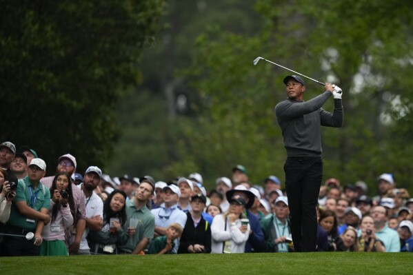 Tiger Woods watches his shot on the fourth hole during a practice round in preparation for the Masters golf tournament at Augusta National Golf Club Tuesday, April 9, 2024, in Augusta, Ga. (AP Photo/Matt Slocum)