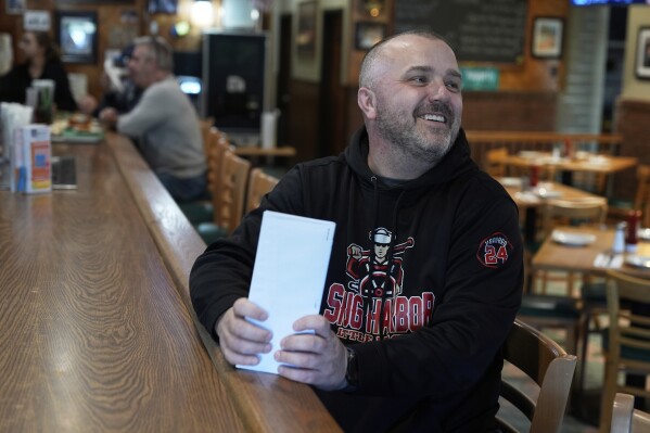 Terence Haggerty talks to customers in his family bar, Jody's Club Forest, in Staten Island, New York, Monday, March 10, 2025. (AP Photo/Seth Wenig)