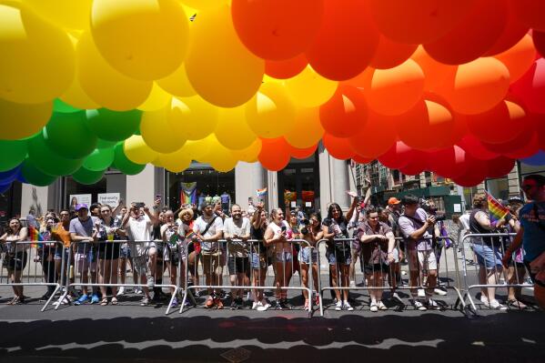 Spectators watch as revelers march down Fifth Avenue during the annual NYC Pride March, Sunday, June 26, 2022, in New York. (AP Photo/Mary Altaffer)