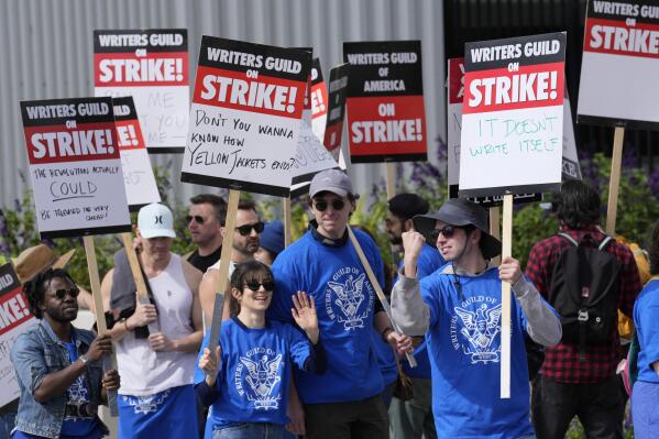 Striking writers rally in front of Netflix offices, Wednesday, May 3, 2023, in Los Angeles. Television and movie writers launched a strike Tuesday for the first time in 15 years, as Hollywood girded for a walkout with potentially widespread ramifications in a fight over fair pay in the streaming era. (AP Photo/Chris Pizzello)