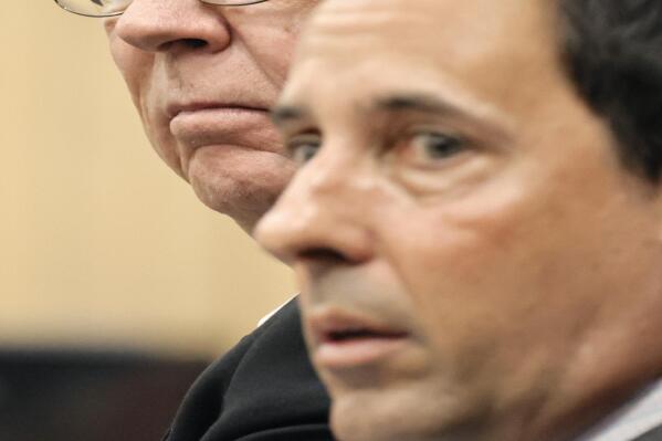 Former Marjory Stoneman Douglas High School School Resource Officer Scot Peterson, left, sits with his defense lawyer Mark Eiglarsh before the start of a hearing at the Broward County Courthouse in Fort Lauderdale, Fla., on Tuesday, May 30, 2023. Peterson is about to be tried on charges he failed to confront the gunman who murdered 14 students and three staff members at a Parkland high school five years ago. (Amy Beth Bennett/South Florida Sun-Sentinel via AP, Pool)