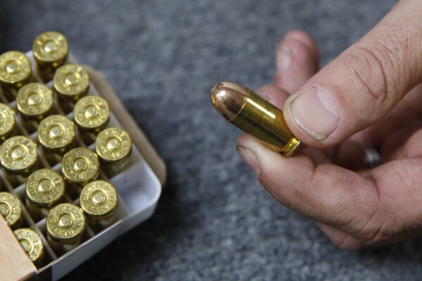 FILE - Chris Puehse, owner of Foothill Ammo, displays .45-caliber ammunition for sale at his store in Shingle Springs, Calif., on June 11, 2019. A federal judge on Tuesday, Jan. 30, 2024, struck down a California law requiring people pay for a background check every time they purchase ammunition. (AP Photo/Rich Pedroncelli, File)