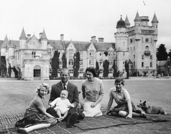 FILE - In this Sept. 1960, photo, Britain's Queen Elizabeth II, Prince Philip and their children, Prince Charles, right, Princess Anne and Prince Andrew, pose for a photo on the lawn of Balmoral Castle, in Scotland. When the hearse carrying Queen Elizabeth II's body pulled out of the gates of Balmoral Castle on Sunday, Sept. 11, 2022, it marked the monarch's final departure from a personal sanctuary where she could shed the straitjacket of protocol and ceremony for a few weeks every year. The sprawling estate in the Scottish Highlands west of Aberdeen was a place where Elizabeth rode her beloved horses, picnicked, and pushed her children around the grounds on tricycles and wagons, setting aside the formality of Buckingham Palace. (AP Photo/File)