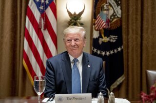 President Donald Trump smiles during a luncheon with members of the United Nations Security Council in the Cabinet Room at the White House in Washington, Thursday, Dec. 5, 2019. (AP Photo/Andrew Harnik)