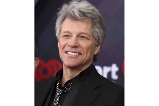 FILE - This March 11, 2018 file photo shows Jon Bon Jovi at the iHeartRadio Music Awards in Inglewood, Calif. A Florida kindergarten teacher took his virtual classroom to new levels on Monday when rock icon Jon Bon Jovi popped in on a writing lesson about life in the coronavirus quarantine. Last month, the 80s rocker released an incomplete version of “Do What You Can,” a ballad about the nation’s battle to contain the virus. He asked fans to submit verses to help complete it. Teacher Michael Bonick sent some of his students' writings about quarantine and Bon Jovi agreed to talk to the class.  (Photo by Jordan Strauss/Invision/AP, File)
