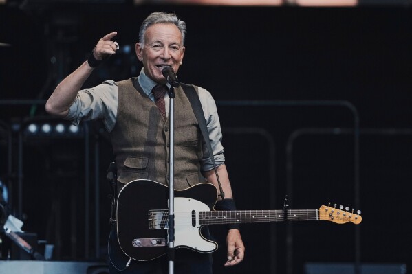 Bruce Springsteen speaks to the audience during a concert with the E Street Band at the Olympic Stadium in Berlin, Germany, on June 11, 2025. (AP Photo/Markus Schreiber, File)