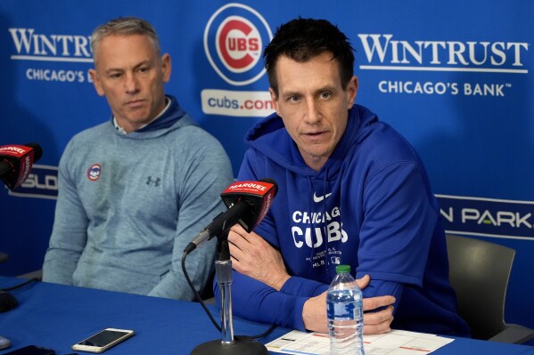 Chicago Cubs manager Craig Counsell, right, speaks as president of baseball operations Jed Hoyer listens during news conference prior to an MLB baseball spring training workout, Wednesday, Feb. 14, 2024, in Mesa, Ariz. (AP Photo/Matt York)
