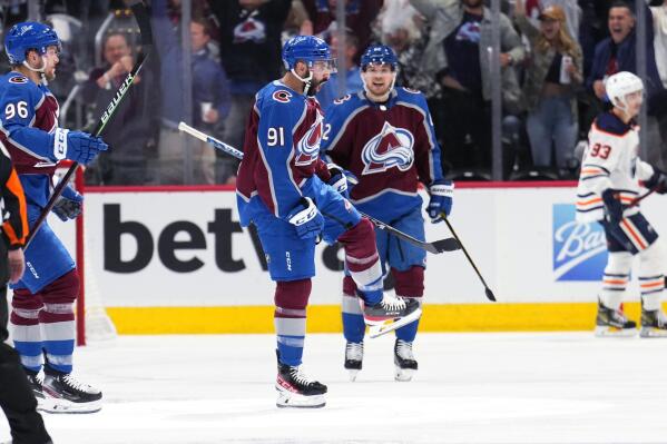 Colorado Avalanche center Nazem Kadri (91) celebrates an Avlanche goal against the Edmonton Oilers during the second period in Game 2 of the NHL hockey Stanley Cup playoffs Western Conference finals Thursday, June 2, 2022, in Denver. (AP Photo/Jack Dempsey)