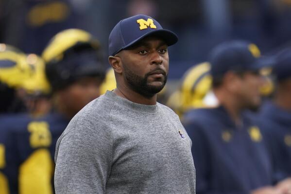 FILE - Michigan co-offensive coordinator Sherrone Moore looks on before an NCAA college football game against Maryland in Ann Arbor, Mich., Sept. 24, 2022. Moore and TCU's Garrett Riley will arrive at the Fiesta Bowl for a College Football Playoff semifinal Saturday, Dec. 31, 2022, as rising-star offensive coordinators. (AP Photo/Paul Sancya, File)