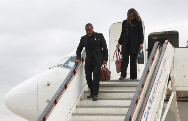 Malawi Vice President Saulos Chilima,left, and his wife Mary disembark from a plane upon his return from South Korea in Lillongwe, Sunday, June 9, 2024. A military plane carrying Malawi's vice president and nine others went missing Monday and a search was underway, the president's office said. The plane carrying 51-year-old Vice President Saulos Chilima left the capital, Lilongwe, but failed to make its scheduled landing at Mzuzu International Airport about 370 kilometers (230 miles) to the north around 45 minutes later. (AP Photo)