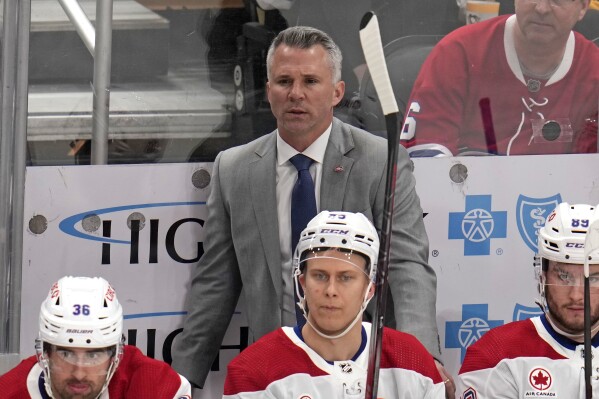 Montreal Canadiens head coach Martin St-Louis stands behind his bench during the first period of an NHL hockey game against the Pittsburgh Penguins in Pittsburgh, Thursday, Feb. 22, 2024. The Penguins won 4-1. (AP Photo/Gene J. Puskar)