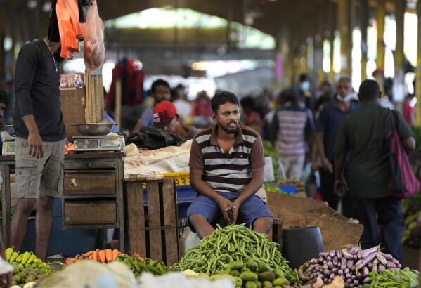 FILE - A vender waits for customers at a vegetable market place in Colombo, Sri Lanka, Friday, June 10, 2022. China’s government on Friday, Feb. 3, 2023, confirmed it is offering Sri Lanka a two-year moratorium on loan repayment as the Indian Ocean island nation struggles to restructure $51 billion in foreign debt that pushed it into a financial crisis. (AP Photo/Eranga Jayawardena)