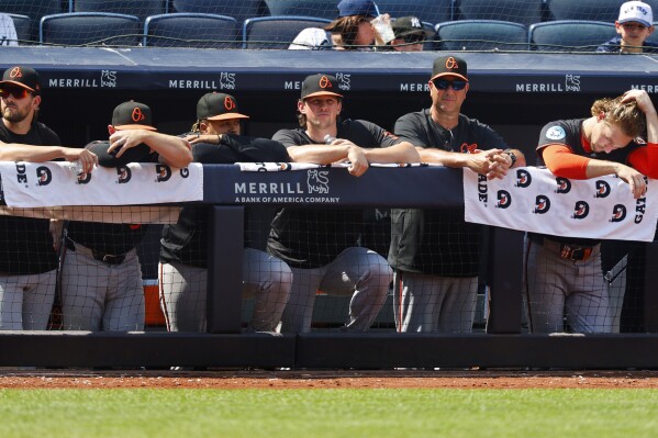 Baltimore Orioles players watch from the dugout railing during the seventh inning of a baseball game against the New York Yankees, Saturday, June 21, 2025, in New York. (AP Photo/Noah K. Murray)