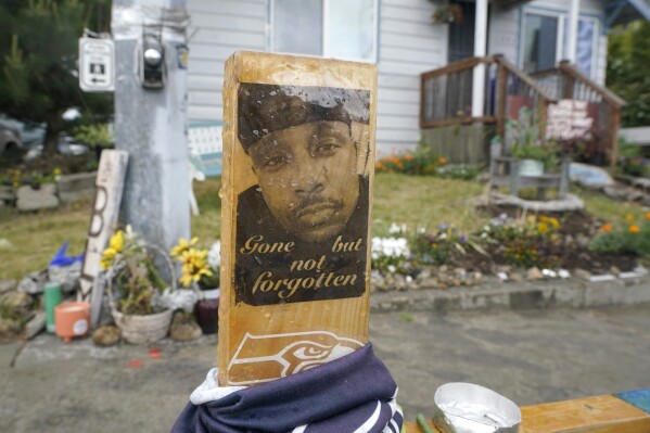 FILE - A sign is displayed on May 27, 2021, at a memorial in Tacoma, Wash., where Manuel "Manny" Ellis died March 3, 2020, after he was restrained by police officers. Opening statements are expected to begin as early as Tuesday, Oct. 3, 2023, in the trial of the three officers charged with Ellis' death. (AP Photo/Ted S. Warren, File)