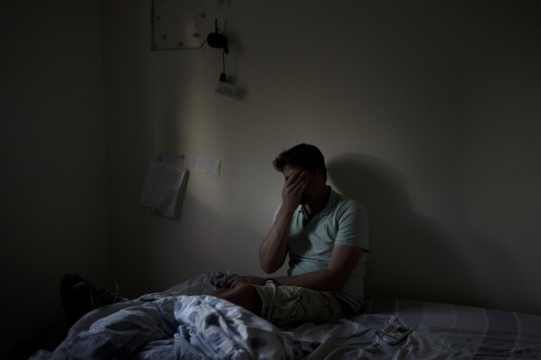 Eyal Barad pauses in the safe room where he sheltered with his family on Oct. 7 as Hamas militants killed and captured a quarter of the community on Kibbutz Nir Oz, Thursday, Nov. 9, 2023. An Associated Press review of hundreds of messages shared among Nir Oz residents, security camera footage and Hamas instruction manuals show the group planned ahead of time to target civilians, a change in tactic that heavily impacted how the war in Gaza played out. (AP Photo/Maya Alleruzzo)