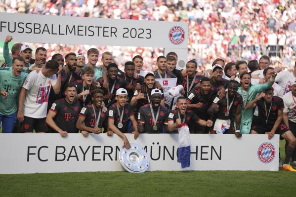 Bayern Munich players celebrate winning the German championship after the German Bundesliga soccer match between 1.FC Cologne and FC Bayern Munich in Cologne, Germany, Saturday, May 27, 2023. (AP Photo/Matthias Schrader)