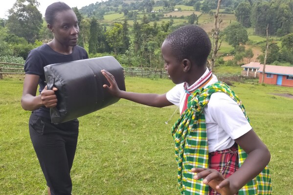 I'm Worth Defending officer Amelia Awuor, left, demonstrates self-defense techniques at Enkakenya Centre for Excellence in Narok County, Kenya, on Feb. 1, 2025. (AP Photo/Nicholas Komu)