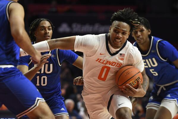 Illinois' Terrence Shannon Jr. (0) works the ball inside against Eastern Illinois' Sincere Malone (5), Kinyon Hodges (10) and Rodolfo Bolis during the first half of an NCAA college basketball game Monday, Nov. 7, 2022, in Champaign, Ill. (AP Photo/Michael Allio)