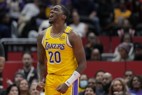 Los Angeles Lakers guard Shake Milton (20) reacts after scoring against the Washington Wizards during the first half of an NBA basketball game Thursday, Jan. 30, 2025, in Washington. (AP Photo/Jess Rapfogel)