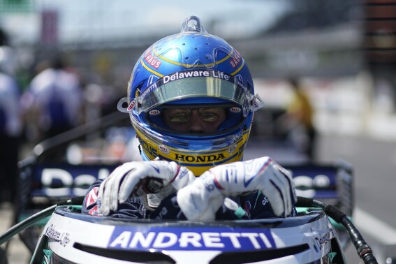 Marcus Ericsson, of Sweden, climbs out of his car following a practice session for the IndyCar Grand Prix auto race at Indianapolis Motor Speedway, Saturday, May 11, 2024, in Indianapolis. (AP Photo/Darron Cummings)
