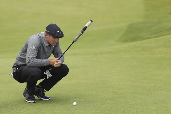 FILE - In this July 18, 2019, file photo, Bryson DeChambeau, of the United States, looks at his putt on the fourth green during the first round of the British Open Golf Championships at Royal Portrush in Northern Ireland. DeChambeau wasted no time defending himself against accusations of slow play Saturday, Aug. 10, after harsh criticism on social media stemming from a video showing him taking more than two minutes to hit an 8-foot putt at The Northern Trust. (AP Photo/Peter Morrison, File)