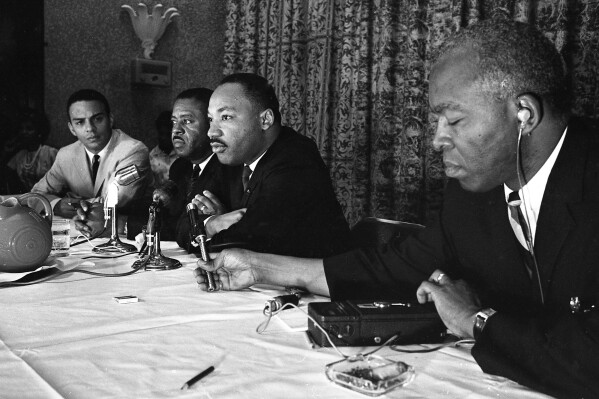 FILE - The Rev. Martin Luther King, center, speaks with the media at the Southern Christian Leadership Conference convention in Savannah, Ga., on Sept. 29, 1964. The March on Washington of 1963 was the product of sustained activism by broad coalition. The Black Church was not monolithic then nor now. (Savannah Morning News via AP, File)