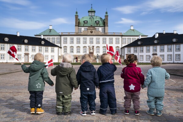 FILE - Children wave Danish flags as they celebrate Denmark's Queen Margrethe's birthday, in Fredensborg, Denmark, on April 16, 2021. Norway's top body for international adoptions on Tuesday recommended a halt to all adoptions from abroad for a two-year period pending an investigation into several allegedly illegal cases, while Denmark's sole overseas adoption agency announced it was stopping for the same concerns. (Martin Sylvest/Ritzau Scanpix via AP, File)