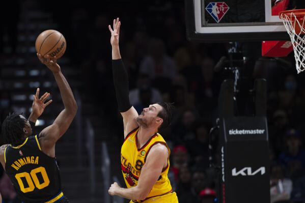 Golden State Warriors forward Jonathan Kuminga (00) shoots over Atlanta Hawks forward Danilo Gallinari (8) during the first half of an NBA basketball game Friday, March 25, 2022, in Atlanta. (AP Photo/Hakim Wright Sr.)