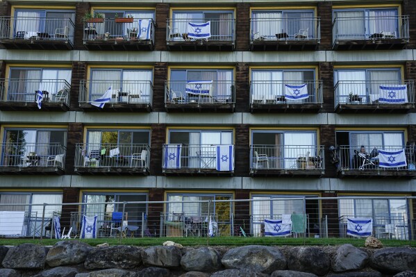 Israeli flags decorate rooms of Israelis who evacuated from cities and towns along the border with Lebanon, in kibbutz Ginosar hotel, northern Israel, Tuesday, March 5, 2024. Around 60,000 Israelis who evacuated from cities and towns along the border with Lebanon are grappling with the question of when they will be able to return home. Hezbollah began launching rockets towards Israel one day after Hamas-led militants stormed into southern Israel on Oct. 7. (AP Photo/Ariel Schalit)