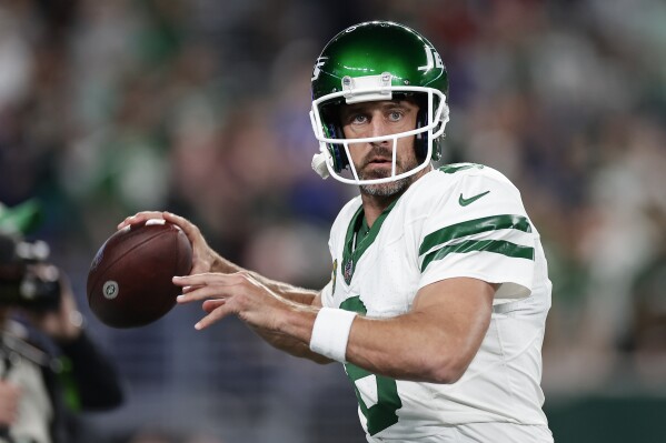 New York Jets quarterback Aaron Rodgers (8) warms up before playing against the Buffalo Bills in an NFL football game, Monday, Sept. 11, 2023, in East Rutherford, N.J. (AP Photo/Adam Hunger)