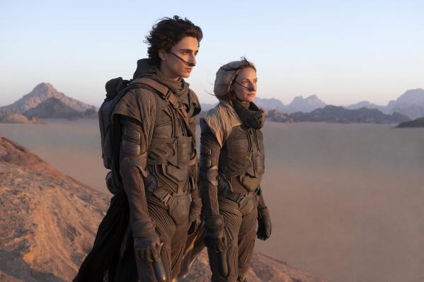 This image released by Warner Bros. Pictures shows Timothee Chalamet, left, and Rebecca Ferguson in a scene from "Dune." (Warner Bros. Pictures via AP)