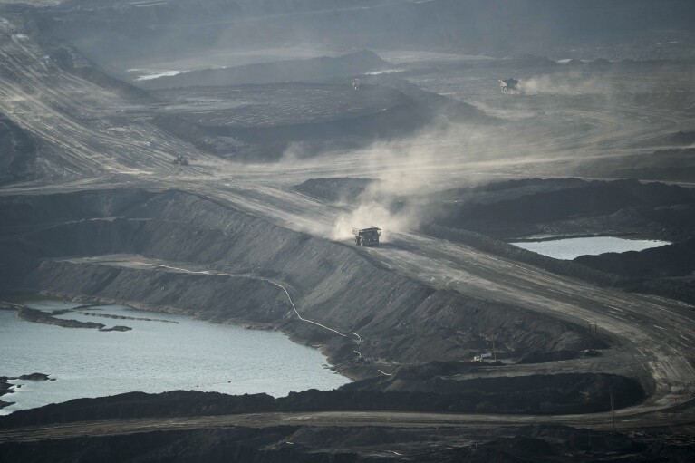 A truck carries oil sand at Suncor's facility near Fort McMurray, Canada, on Friday, Sep. 1, 2023. (AP Photo/Victor R. Caivano)