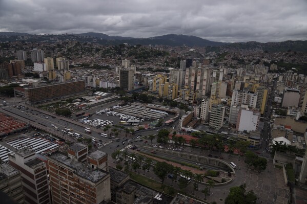 Cars circulate along Bolivar Avenue past La Bandera bus terminal in downtown Caracas, Venezuela, Sept. 12, 2022.  (AP Photo/Ariana Cubillos, File)