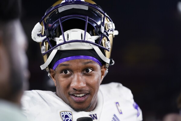 Washington quarterback Michael Penix Jr. is interviewed after the team's win over Southern California in an NCAA college football game, Saturday, Nov. 4, 2023, in Los Angeles. (AP Photo/Ryan Sun)